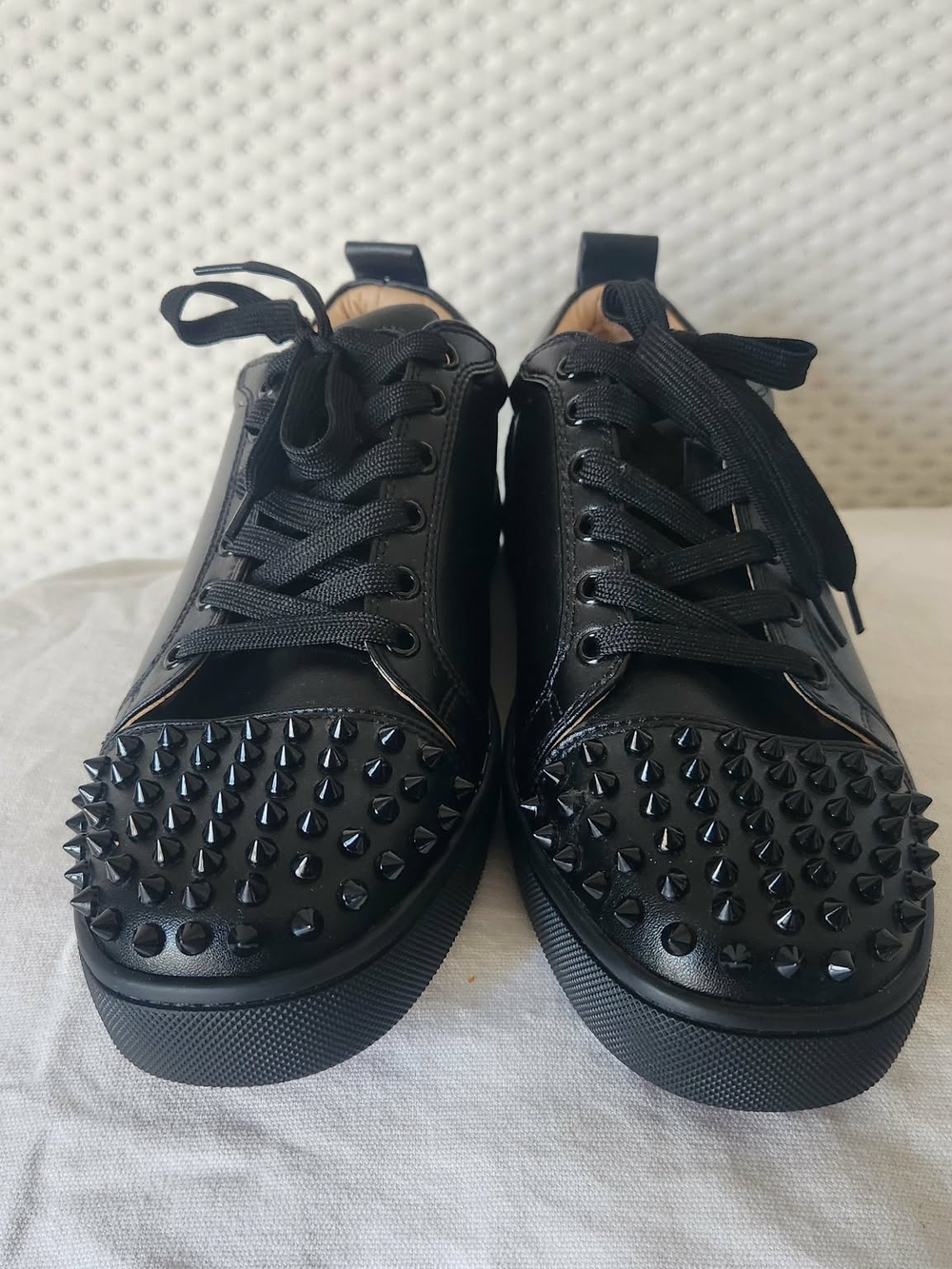 Christian Louboutin Louis Junior Spikes sneakers in black calf leather. 